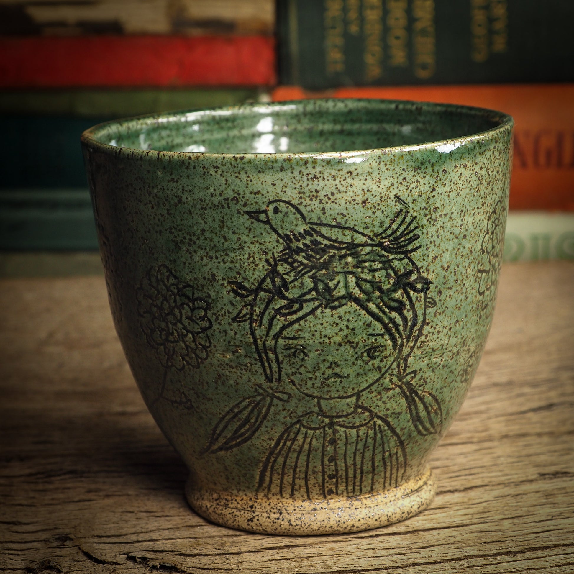 An original glazed ceramic mug by Idania Salcido, the artist behind Danita Art. It measures 4 x 4 x 3.5 Inches, with deep green hue glazes and hand decorated figures on the sides. Totally handmade in my studio, this is a unique piece that cannot be repeated. Food and drink safe, hand wash only.