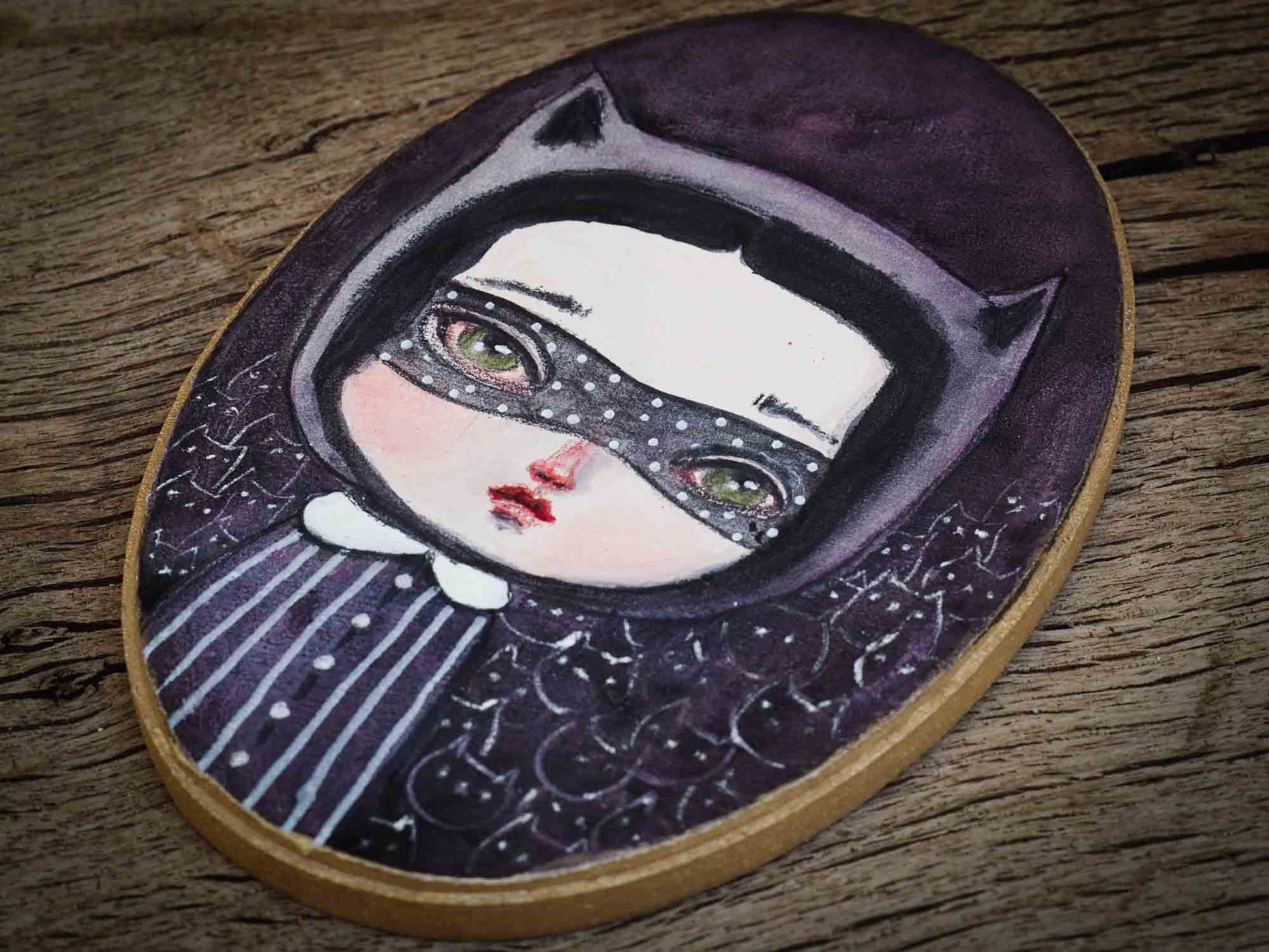 When I think of Cat Lady, I imagine a powerful woman with an army of cats at her disposal, so I painted this little girl in an oval wood canvas. I used watercolors to create an army of black cats with a mysterious ambiance where the cats are lookin right back at you, lurking in the shadows waiting to do her bidding.