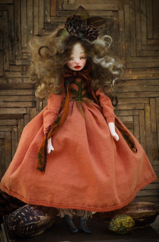 This is an original hand made Danita Art doll. She is inspired by the warm colors of leaves falling, pine cones and the beautiful scents of the forest in Autumn.  Her name is ELA and she is protector of the trees and speaks for them. Dressed in a handmade burnt orange gown. Her hair is made of natural wool and she is wearing beautiful pine cones in her head.