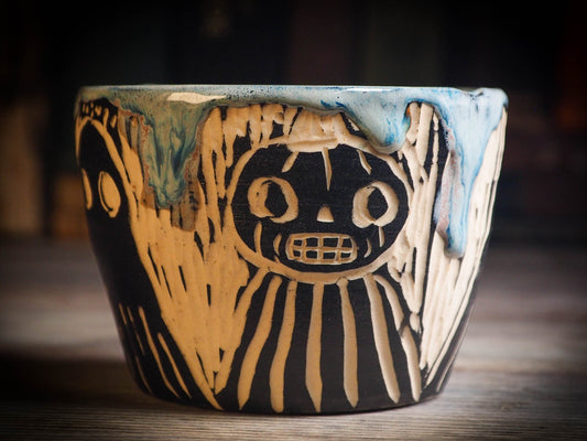 An original Halloween ceramic mug tumbler bowl handmade by Idania Salcido the artist behind Danita Art. Made with wheel thrown clay hand carved and glazed by the artist. Witches, ghosts, goblins, black cats, vampires give a folk art primitive feel to it. Perfect for Halloween Candy, ice cream and fruit, a pet cat bowl.