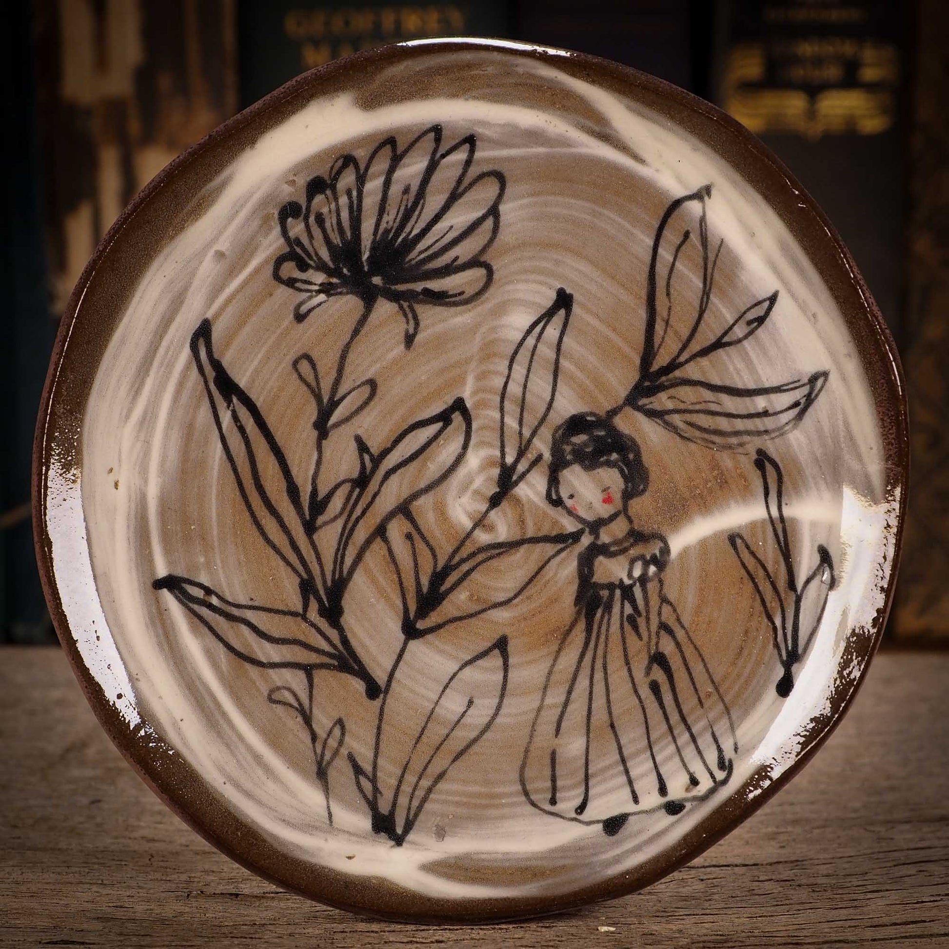 An original glazed ceramic food plate by Idania Salcido, the artist behind Danita Art. Totally handmade in my studio, this is a unique piece that cannot be repeated. Food and drink safe, hand wash only. Brown earth tones and an ink drawing of a girl on the outside.