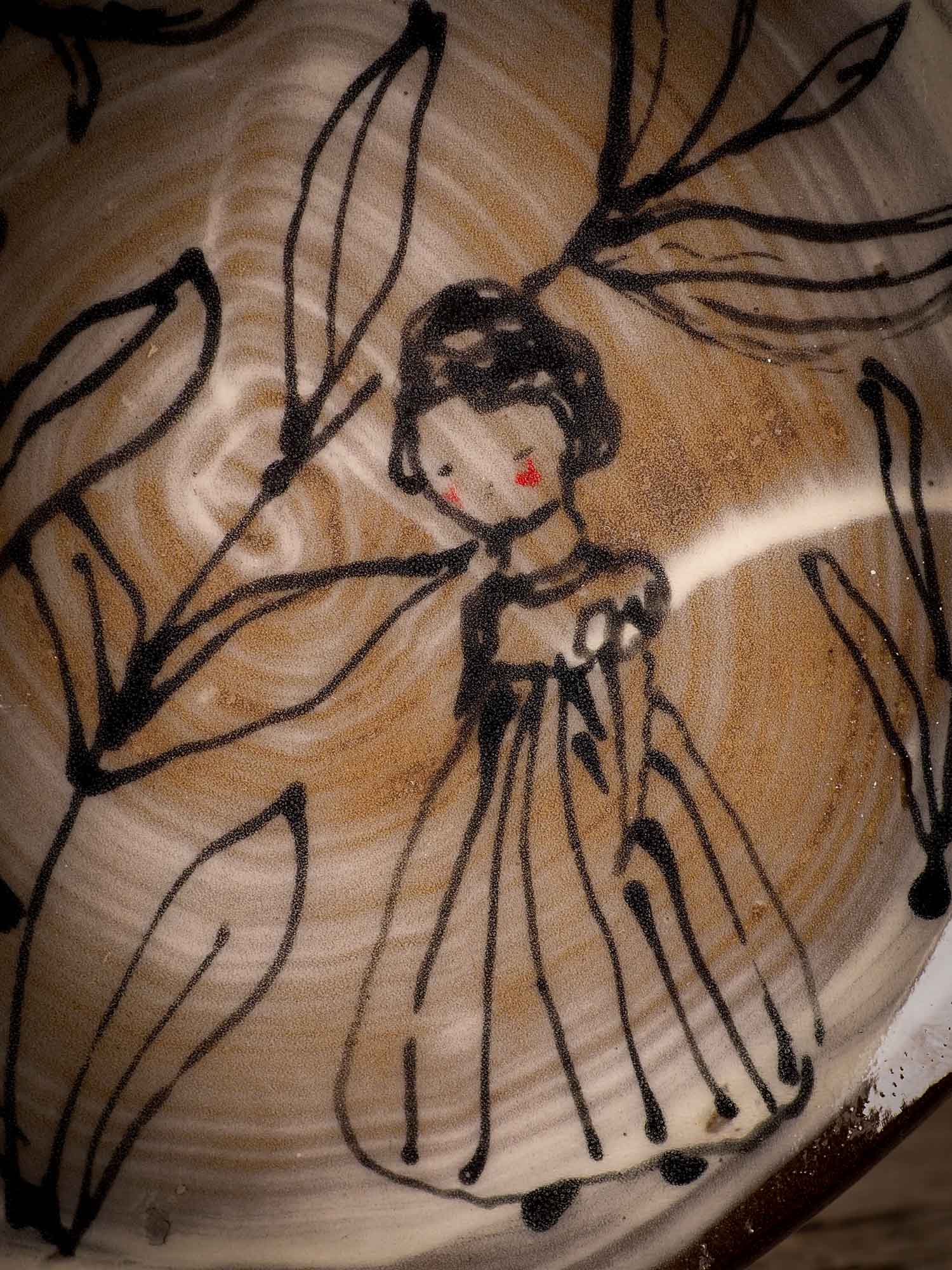 An original glazed ceramic food plate by Idania Salcido, the artist behind Danita Art. Totally handmade in my studio, this is a unique piece that cannot be repeated. Food and drink safe, hand wash only. Brown earth tones and an ink drawing of a girl on the outside.
