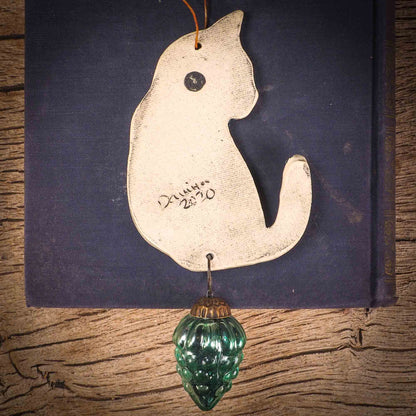 An original Christmas Holiday tree ornament ceramic cat, handmade by Idania Salcido the artist behind Danita Art. Glazed carved sgraffito stoneware, hand painted and decorated, it has a beautiful vintage glass tree ornament to adorn a unique holiday gift for family and friends. Christmas gift for animal and pet lovers.
