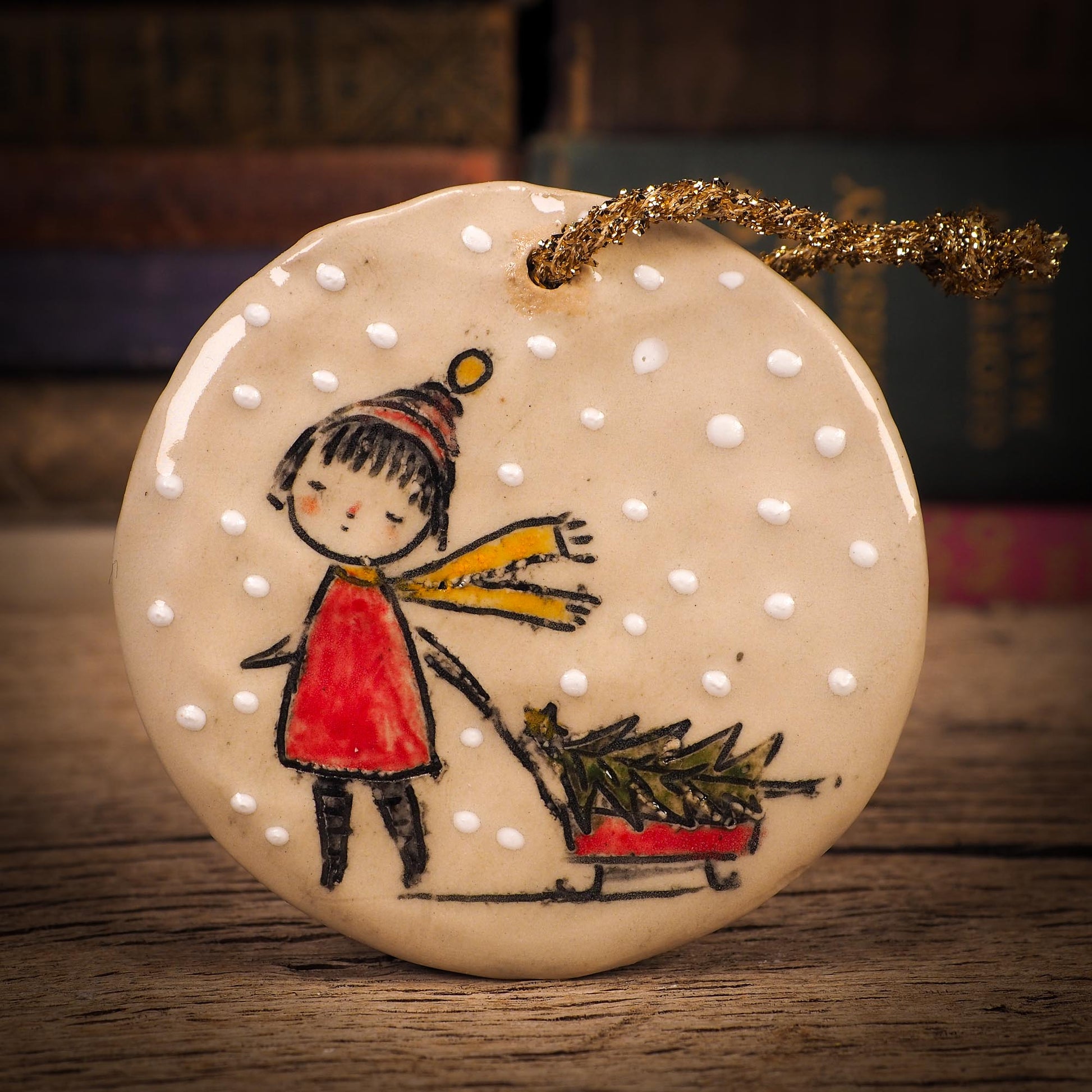 An original Christmas Holiday tree round glazed ceramic ornament handmade by Idania Salcido, the artist behind Danita Art. Glazed carved sgraffito stoneware, hand painted and decorated, it is illustrated by hand with winter scenes with snowmen, Christmas trees, Santa Claus, snow balls and winter themes.