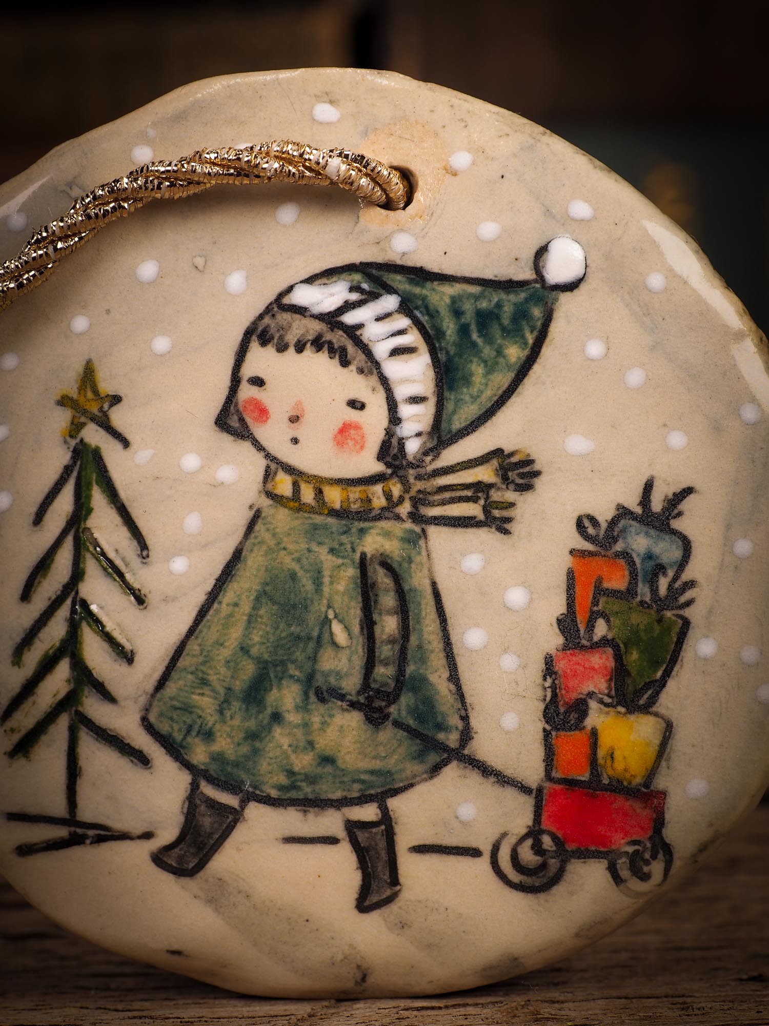 An original Christmas Holiday tree round glazed ceramic ornament handmade by Idania Salcido, the artist behind Danita Art. Glazed carved sgraffito stoneware, hand painted and decorated, it is illustrated by hand with winter scenes with snowmen, Christmas trees, Santa Claus, snow balls and winter themes.