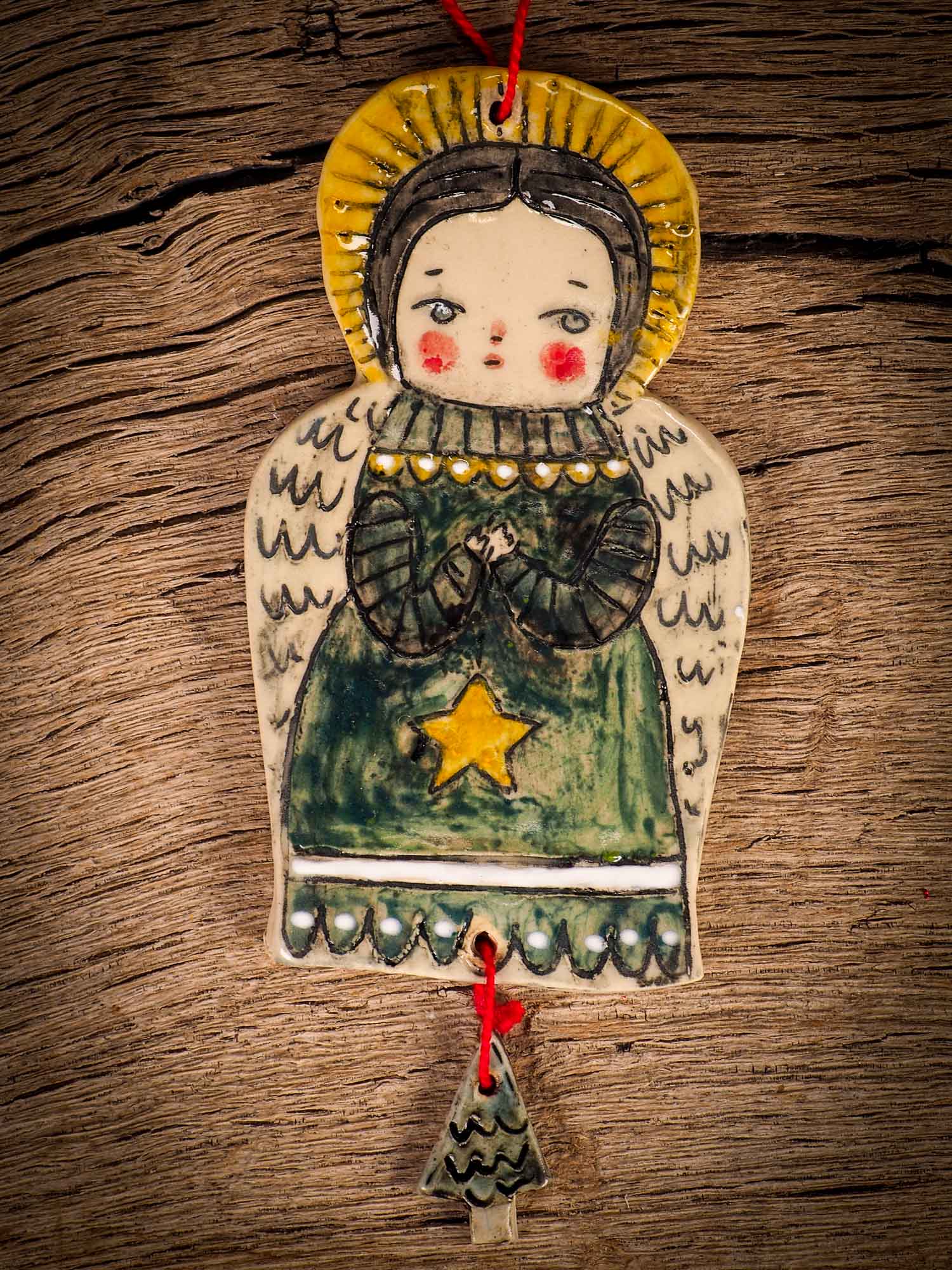 An original Christmas Holiday tree round glazed ceramic ornament handmade by Idania Salcido, the artist behind Danita Art. Glazed carved sgraffito stoneware, hand painted and decorated, it is illustrated by hand with snowmen, Christmas trees, Santa Claus, angels and snow balls and winter themes.