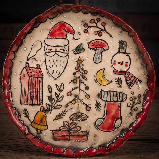 An original Christmas Holiday cake dinner dessert plate round glazed ceramic dinnerware handmade by Idania Salcido, the artist behind Danita Art. Glazed carved sgraffito stoneware, hand painted and decorated, it is illustrated by hand with snowmen, Christmas trees, Santa Claus, angels and snow balls and winter themes.