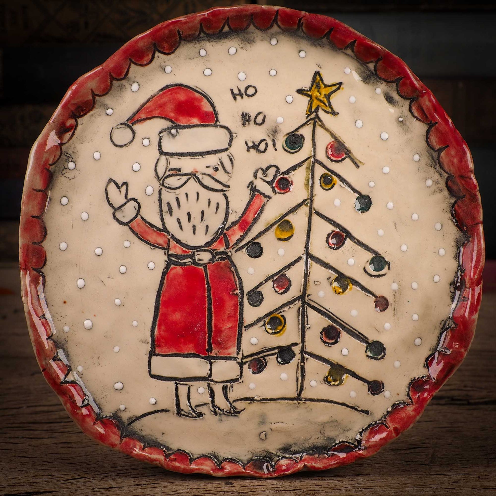 An original Christmas Holiday cake dinner dessert plate round glazed ceramic dinnerware handmade by Idania Salcido, the artist behind Danita Art. Glazed carved sgraffito stoneware, hand painted and decorated, it is illustrated by hand with snowmen, Christmas trees, Santa Claus, angels and snow balls and winter themes.