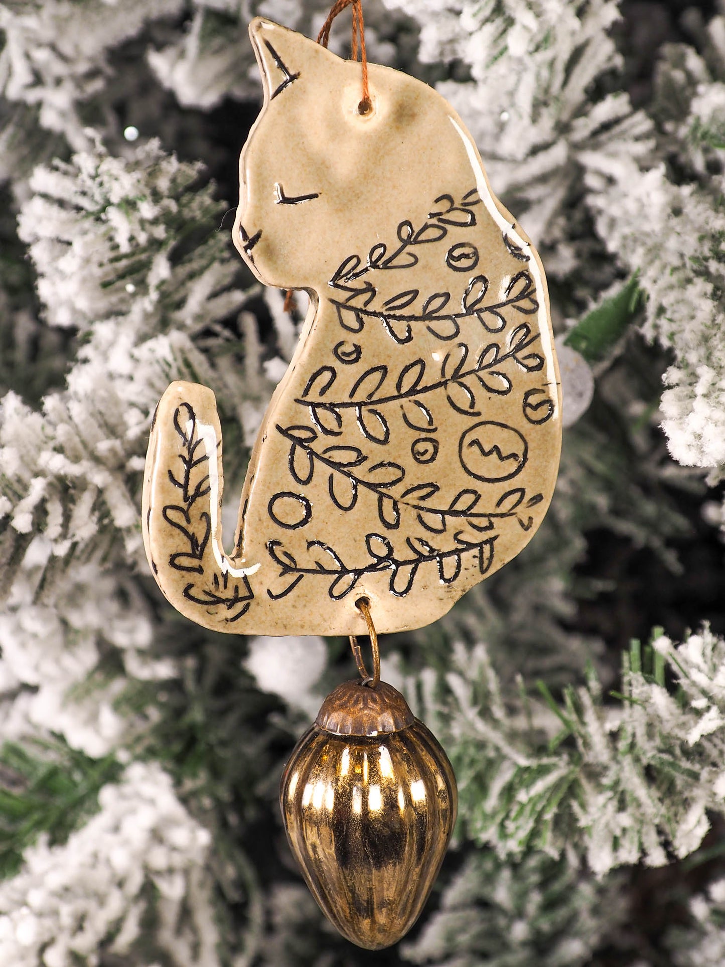An original Christmas Holiday tree ornament ceramic cat, handmade by Idania Salcido the artist behind Danita Art. Glazed carved sgraffito stoneware, hand painted and decorated, it has a beautiful vintage glass tree ornament to adorn a unique holiday gift for family and friends. Christmas gift for animal and pet lovers.