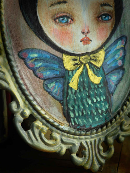 The boy with butterfly wings has beautiful wings painted in iridescent colors. Original by Danita Art.